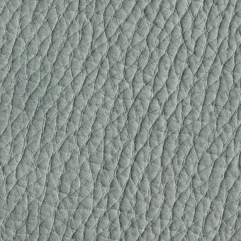 Gray nubuck leather texture with repeating diamond indentations in horizontal rows, exhibiting a matte finish and natural grain variations.
